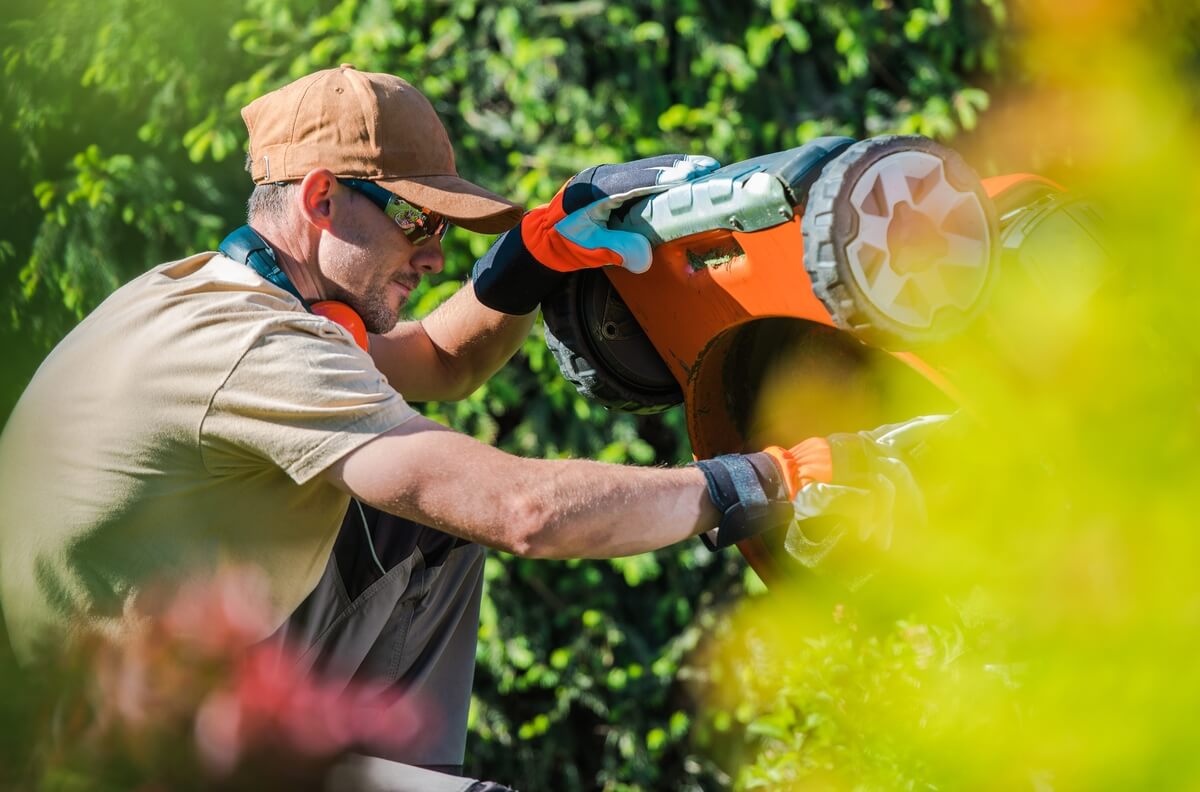 men fixing lawn mower